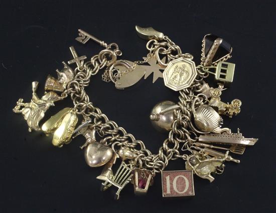 A 1960s 9ct gold charm bracelet, hung with twenty seven assorted mainly 9ct gold charms,